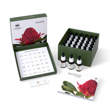 A Stock Kit of 71 Essences from Australia, including essence bottles, a practitioner label book, and a reference book displayed within a green box.